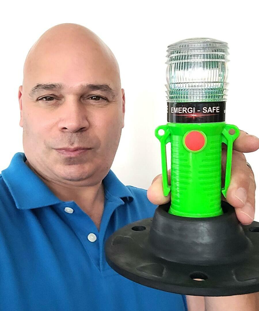 Danny Vartan holding the EMERGI-SAFE with base plate